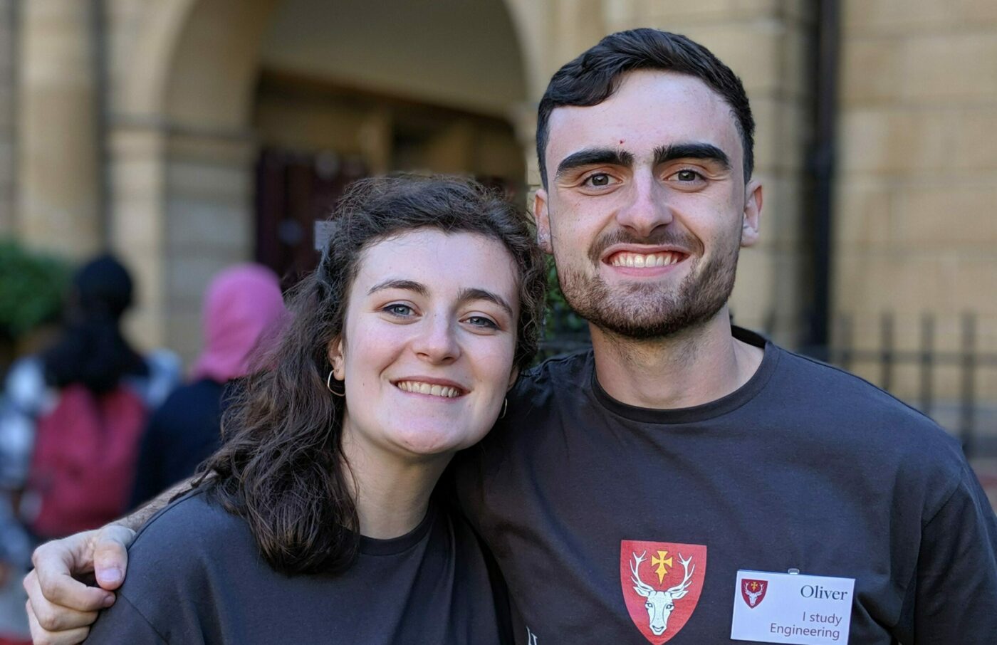 two young people in grey Hertford college t-shirts